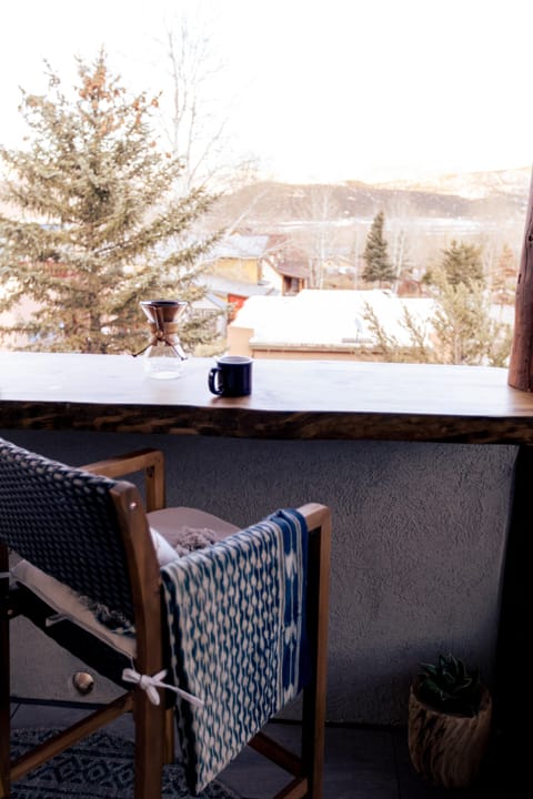 Spacious porch with bar seating, as well as lounge seating and radiant heaters.