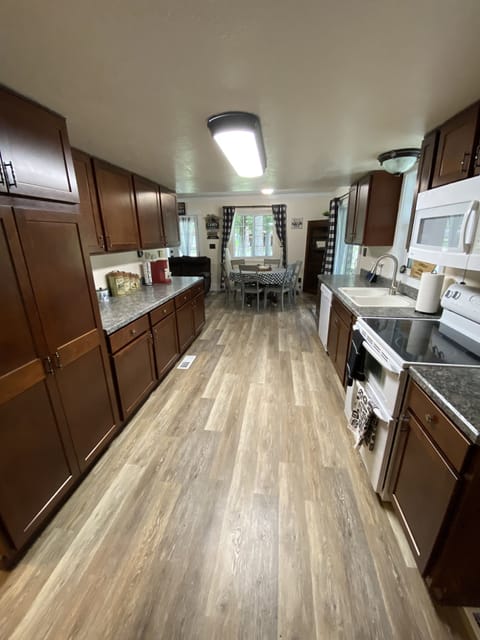 Full kitchen with dishwasher, double oven, microwave and large fridge