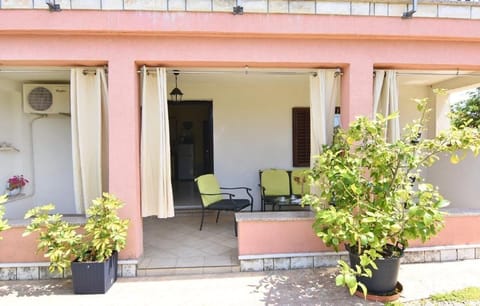 The covered terrace at the entrance equipped with garden furniture