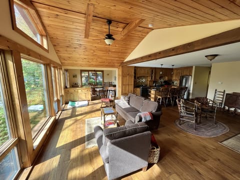 Sunlit Great Room (extends into dining area, kitchen, and seating by wood stove)