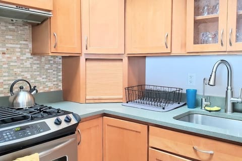 Kitchen has cookware, bakeware, cooking oil, salt, pepper, sugar, and cleaning supplies