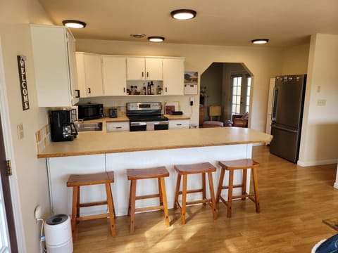 Front entry view into kitchen, main living, and hallway to bedrooms & bathroom.