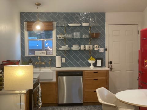 Kitchen with floating glass shelves, fully stocked for your use.