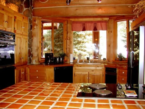 Large gourmet country kitchen with cook stove island and built in double ovens