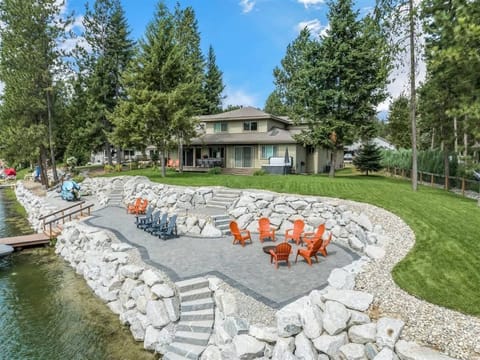 Brand new back yard with a fire pit, lounge area, and easy access to the dock