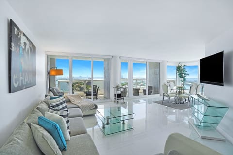 Living area, dining room, balcony access, Roku streaming tv