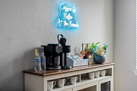 The neon sign says it all—your beachside mornings just got an upgrade.