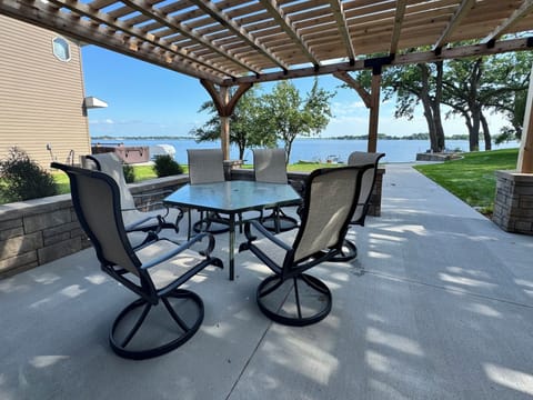 Lakeside patio dining area with shady pergola