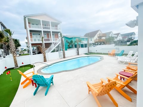 Beautiful backyard oasis with 2 putting greens and large, private pool.  