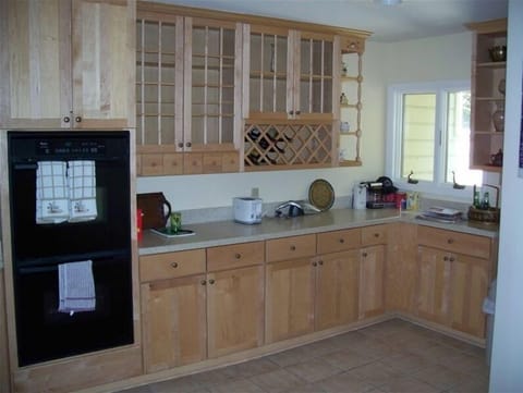 Kitchen with double oven, new cabinets and Corian countertops