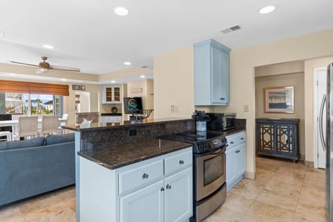 Start your day with coffee at the cozy breakfast nook or gather around the bar stools for casual dining, all while soaking in peaceful views of the sparking canal.

Professionally Managed By 
Breathe Easy Rentals