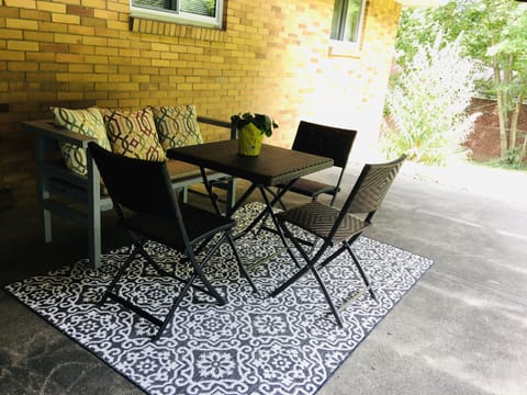 Relax on the covered patio facing a private scenery backyard