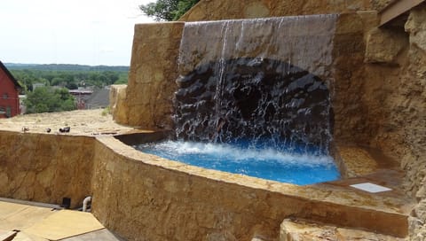 Beautiful ancient castle-like stone work waterfall cave and dipping pond.