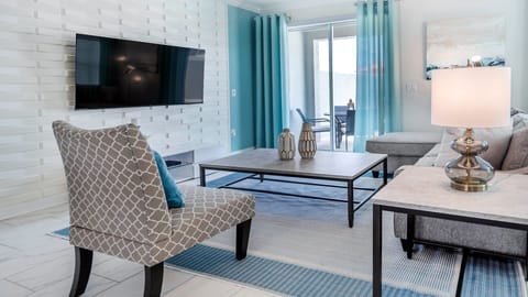 Unwind on plush couches, enjoying a cinematic experience on a luxurious big-screen TV.