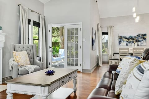 Sunlit living room with plush seating and patio access invites relaxed mornings and evenings, a true A Stay Above The Rest.