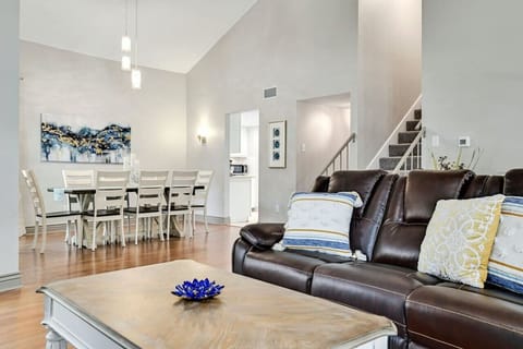 Spacious layout with inviting leather sofa and dining area creates an ideal gathering spot, elevated by A Stay Above The Rest.