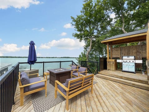Firepit and BBQ with waterfront views on the upper deck