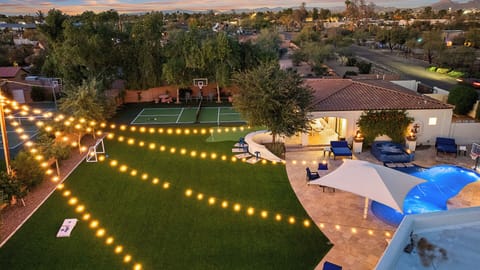 Private desert escape with lawn, resort pool, and mountain views under the stars