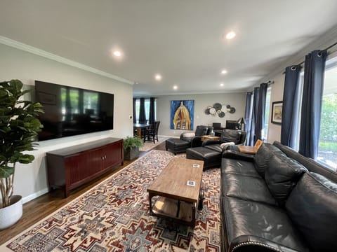 Living room with 75” Smart TV, Office Desk