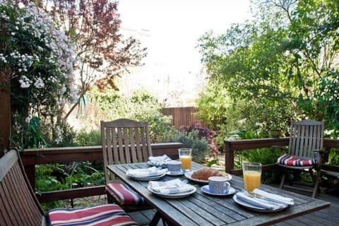 Dine al fresco on your private deck overlooking the garden.