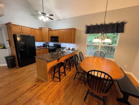 Kitchen table seats 7 with room for 3 more at the peninsula.