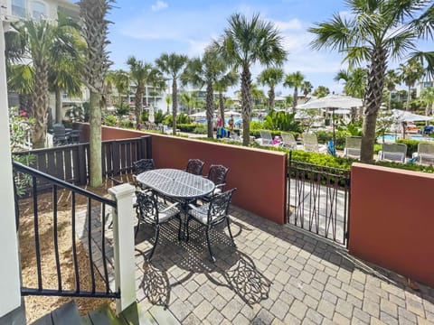 Furnished patio with a table, chairs, and umbrella