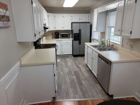 Well appointed kitchen-door leading out to fully fenced yard and deck