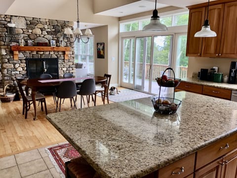 View of kitchen/dining area with double-sided fireplace