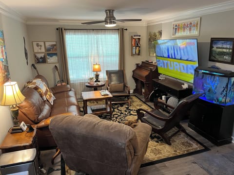 Living room features a 75 inch smart tv w/ 3 recliners & seating for 6