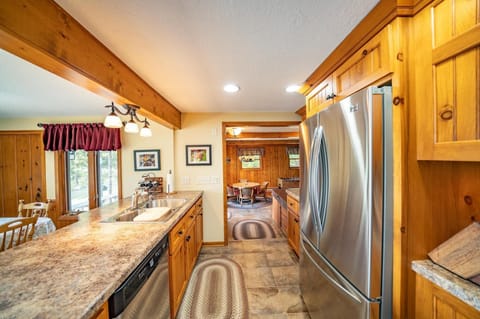 Centrally located and open kitchen.  Looking into game room with card table & TV