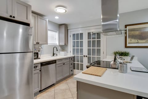 Newly renovated kitchen. French doors lead to full laundry.