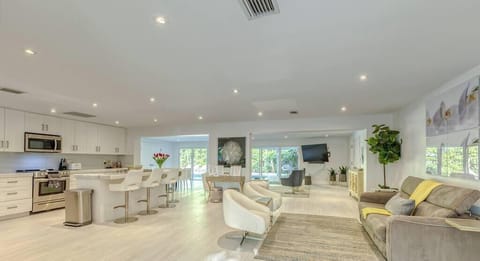 Open floor plan perfect for entertaining.  Open chef's kitchen fully stocked with everything you need to cook and bonus area with a Queen Sleeper Sofa. Triple sliding doors that open to expansive resort-style back yard, pool, hot tub & putting green. 