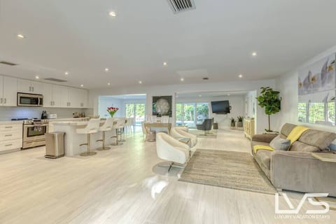 Open floor plan perfect for entertaining.  Open chef's kitchen fully stocked with everything you need to cook and bonus area with a Queen Sleeper Sofa. Triple sliding doors that open to expansive resort-style back yard, pool, hot tub & putting green. 