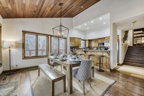Savor meals in your open-concept dining space with rustic wood ceilings, modern fixtures, and a fully equipped kitchen at your fingertips.