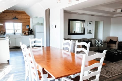 The open concept first floor seamlessly includes living room, dining room, kitchen, and breakfast nook (around the corner to the right in the kitchen).