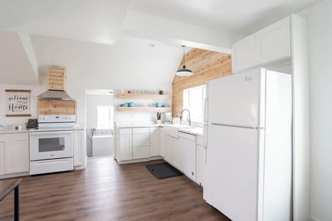 The laundry room is conveniently located next to the kitchen. The kitchen window has a clear view outside to the fire pit.