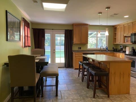 Kitchen seating at dining room table and island bar.