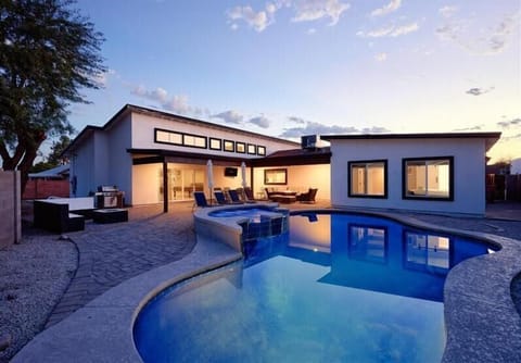 Backyard oasis with pool, hot tub, lounge chairs, fire pit, BBQ grill, an outdoor dining table, outdoor seating, and a smart TV!