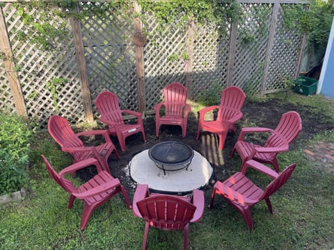Fenced backyard with a fire pit