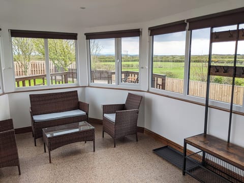Conservatory with garden and countryside views | Brambleside, Mawbray near Allonby