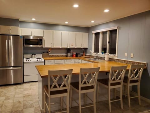 Kitchen offers additional seating. Microwave and stove are newer than pictured.