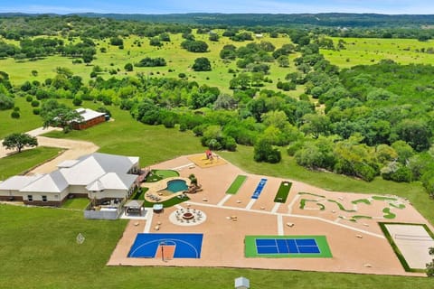 [Resort Property] Aerial view of the property showing basketball court, volleyball, pickleball, mini golf, heated pool, fire pit, and more!