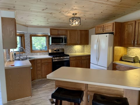 Countertop has 2 bar stools for additional seating space