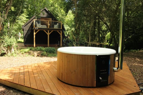 Quality Swedish wood fired hot tub and studio in background