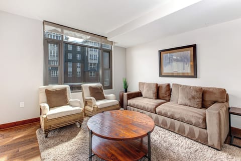 Lowell 402 living room with comfortable seating and flat screen TV.