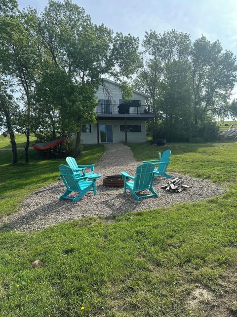 Backyard oasis with fire pit, hammock, and large deck. Yard games stored inside.