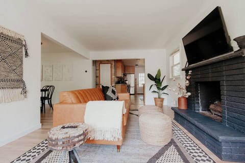 Open concept Living room with smart tv and leather couch