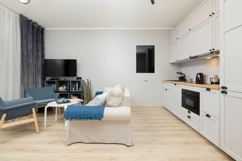 Kitchenette with plenty of kitchen utensils and dishes.