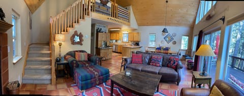 Living room on main floor next to stairs to loft. 
