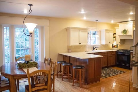 Open kitchen with island seating and dining table to seat 6 